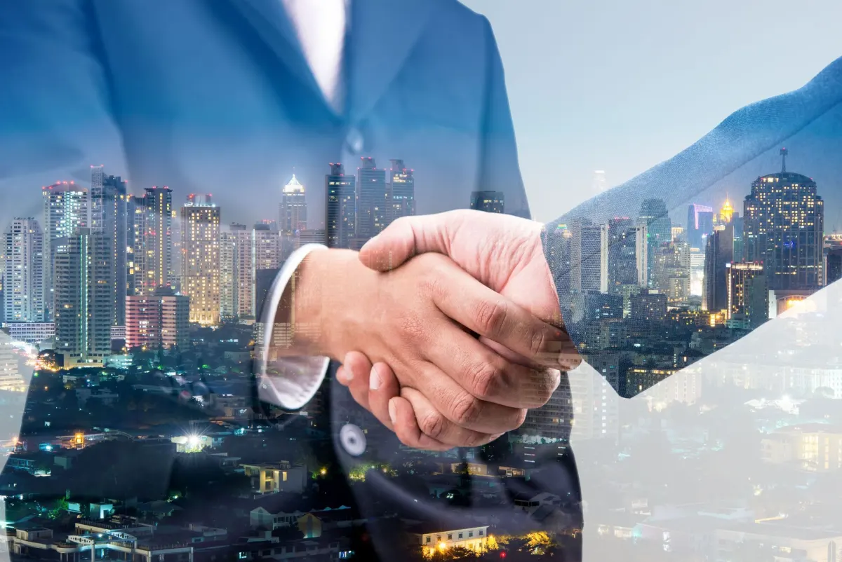 Handshake over a city skyline